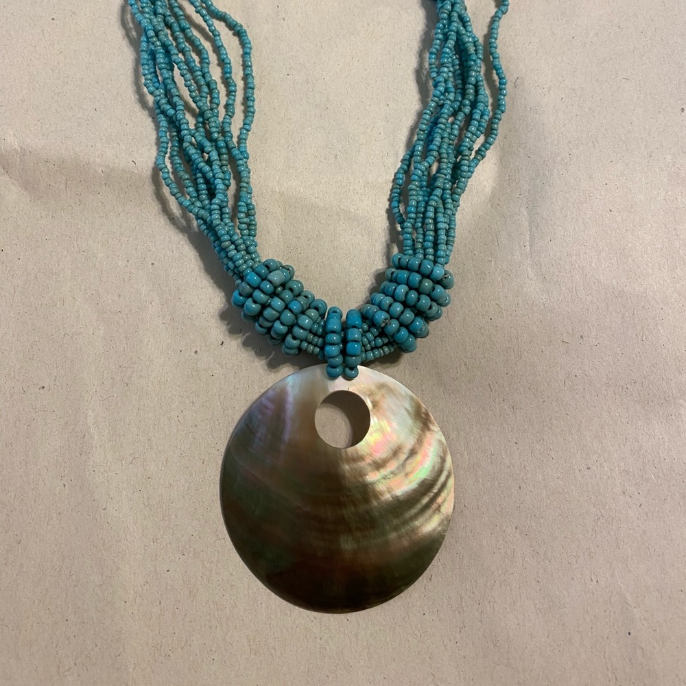 Turquoise colored beaded necklace with pendant